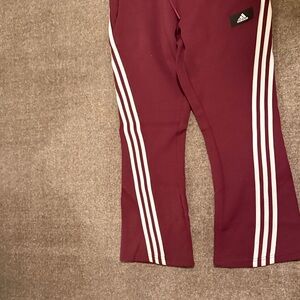 Adidas woman’s Burgundy Joggers with White Stripes